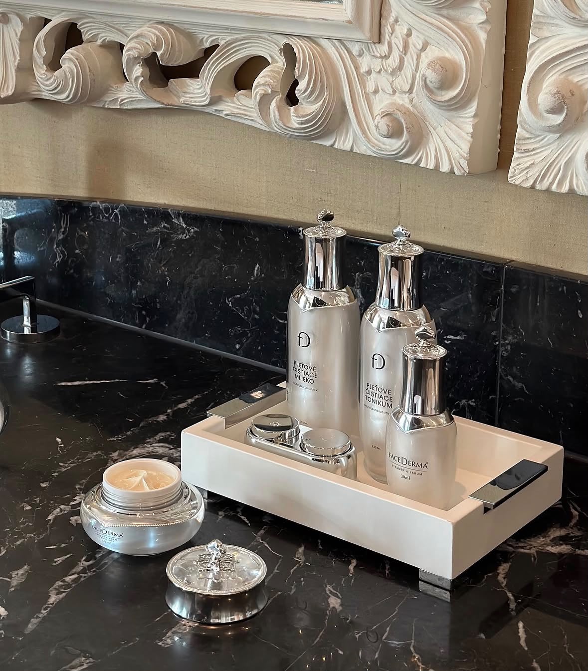 Facederma skincare collection on a marble counter